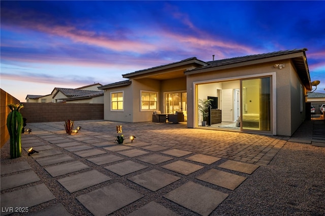 11672 Barga Ct, Las Vegas, NV 89138 - back of house featuring a patio, stucco siding, a fenced backyard, and a tile roof