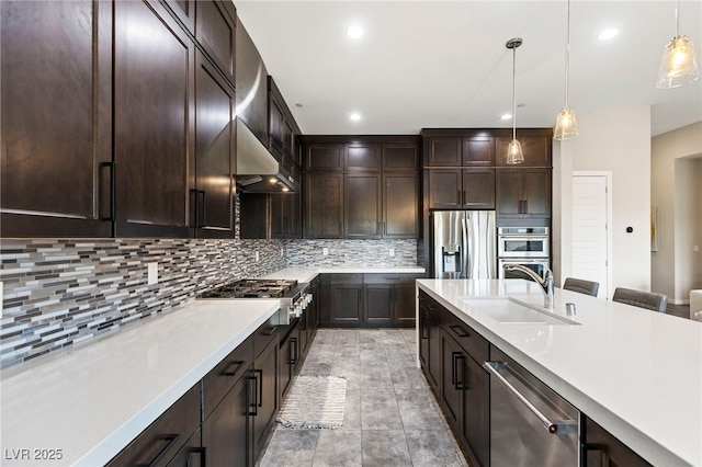 11672 Barga Ct, Las Vegas, NV 89138 - kitchen featuring stainless steel appliances, a sink, dark brown cabinets, light countertops, and hanging light fixtures