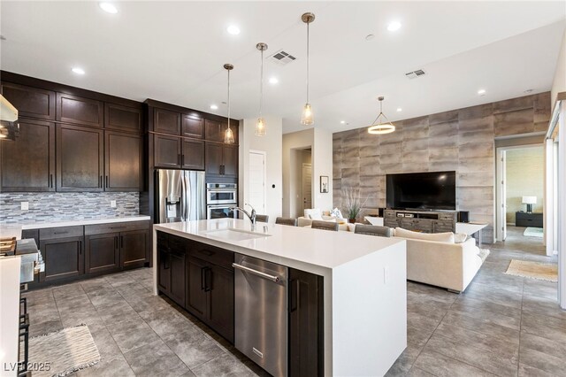 11672 Barga Ct, Las Vegas, NV 89138 - kitchen featuring appliances with stainless steel finishes, a sink, light countertops, dark brown cabinetry, and recessed lighting