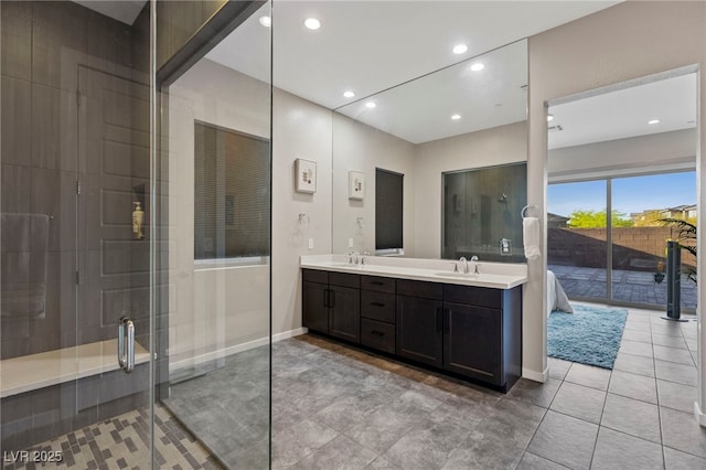 11672 Barga Ct, Las Vegas, NV 89138 - bathroom featuring double vanity, a stall shower, recessed lighting, baseboards, and tile patterned floors