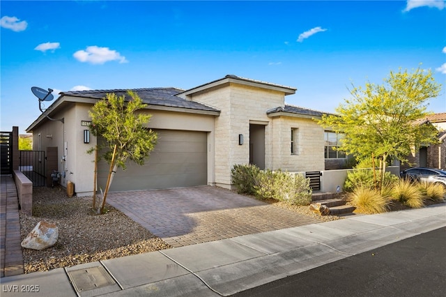 11672 Barga Ct, Las Vegas, NV 89138 - prairie-style house with decorative driveway, a garage, a gate, stucco siding, and stone siding