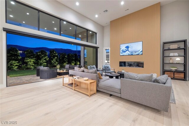 10781 Agate Cliffs Ave, Las Vegas, NV 89135 - living room featuring a towering ceiling, wood finished floors, and recessed lighting