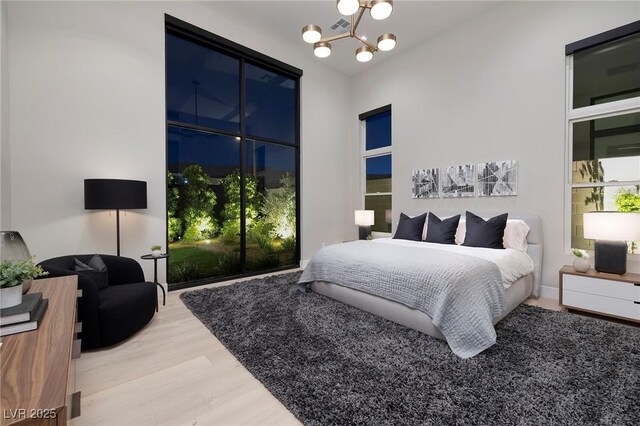 10781 Agate Cliffs Ave, Las Vegas, NV 89135 - bedroom featuring wood finished floors and a chandelier