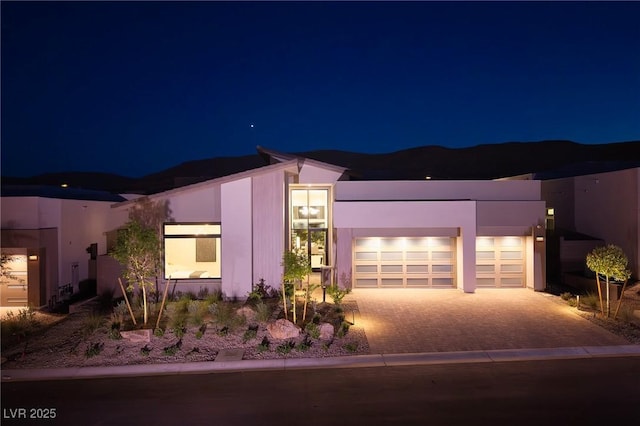 10781 Agate Cliffs Ave, Las Vegas, NV 89135 - view of front facade with driveway, an attached garage, and stucco siding