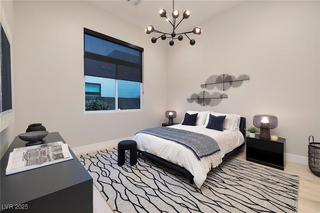 10781 Agate Cliffs Ave, Las Vegas, NV 89135 - bedroom featuring a chandelier, baseboards, and wood finished floors