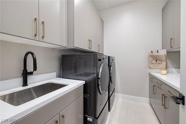 10781 Agate Cliffs Ave, Las Vegas, NV 89135 - washroom featuring washer and dryer, cabinet space, baseboards, and light tile patterned flooring