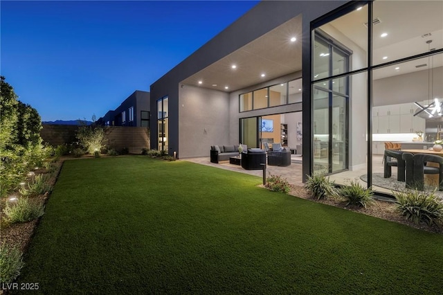 10781 Agate Cliffs Ave, Las Vegas, NV 89135 - view of green lawn with an outdoor living space and a patio