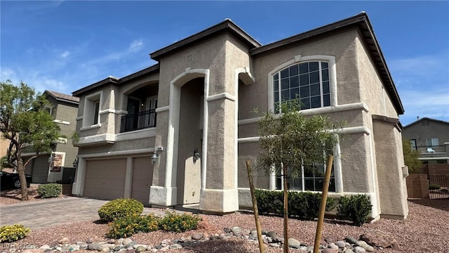 10066 Golden Bluff Ave, Las Vegas, NV 89148 - view of front of house featuring stucco siding, a garage, a balcony, and driveway