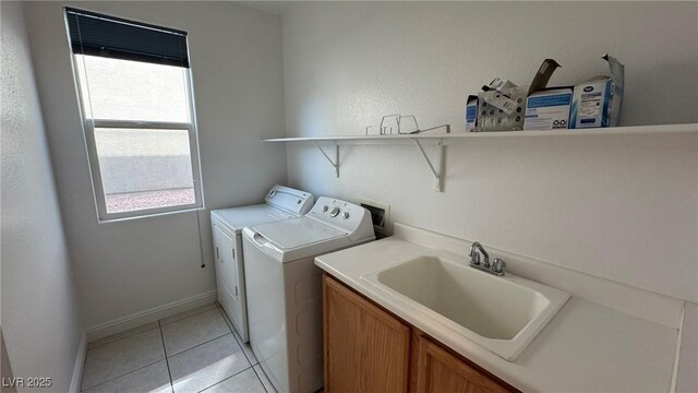 10066 Golden Bluff Ave, Las Vegas, NV 89148 - laundry room featuring washing machine and clothes dryer, plenty of natural light, light tile patterned flooring, and baseboards