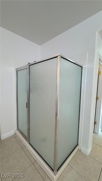 10066 Golden Bluff Ave, Las Vegas, NV 89148 - bathroom featuring tile patterned flooring, baseboards, and a stall shower