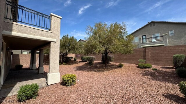 10066 Golden Bluff Ave, Las Vegas, NV 89148 - fenced backyard with a patio and a balcony