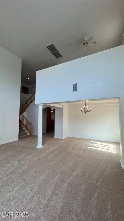 10066 Golden Bluff Ave, Las Vegas, NV 89148 - unfurnished living room featuring carpet, a chandelier, a ceiling fan, and stairway