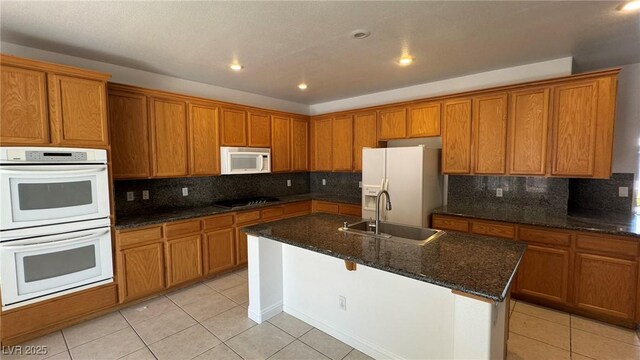 10066 Golden Bluff Ave, Las Vegas, NV 89148 - kitchen featuring a sink, white appliances, brown cabinetry, light tile patterned floors, and recessed lighting