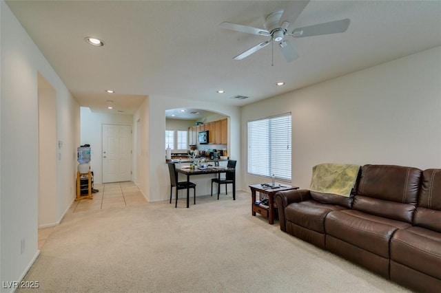 7645 Interlace St, Las Vegas, NV 89149 - living area featuring light carpet, recessed lighting, ceiling fan, arched walkways, and baseboards