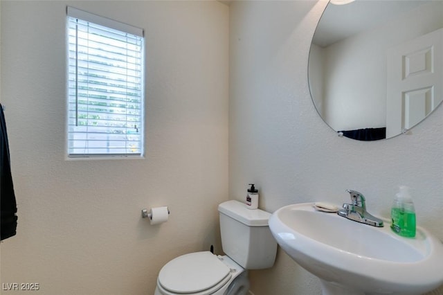 7645 Interlace St, Las Vegas, NV 89149 - bathroom featuring healthy amount of natural light, a sink, and toilet