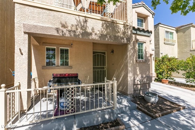 7645 Interlace St, Las Vegas, NV 89149 - entrance to property featuring stucco siding and a tiled roof