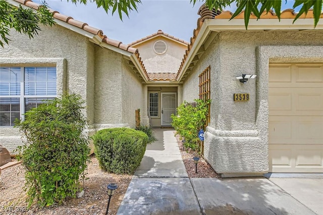 3539 Barrel Bronco Ct, North Las Vegas, NV 89032 - doorway to property with stucco siding, a garage, and a tiled roof