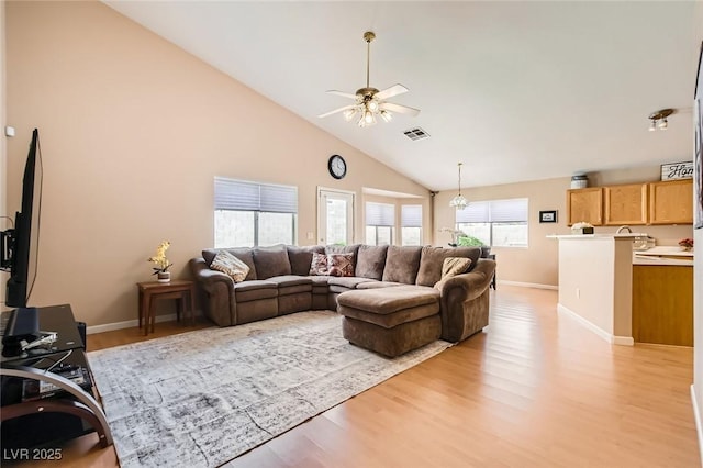 3539 Barrel Bronco Ct, North Las Vegas, NV 89032 - living room with ceiling fan, high vaulted ceiling, light wood-type flooring, and baseboards