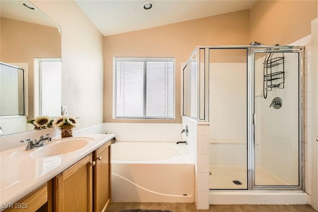 3539 Barrel Bronco Ct, North Las Vegas, NV 89032 - bathroom featuring vaulted ceiling, a stall shower, a bath, and vanity