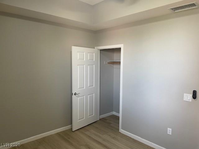 15 E Agate Ave Unit 202, Las Vegas, NV 89123 - unfurnished bedroom featuring wood finished floors, baseboards, and a closet