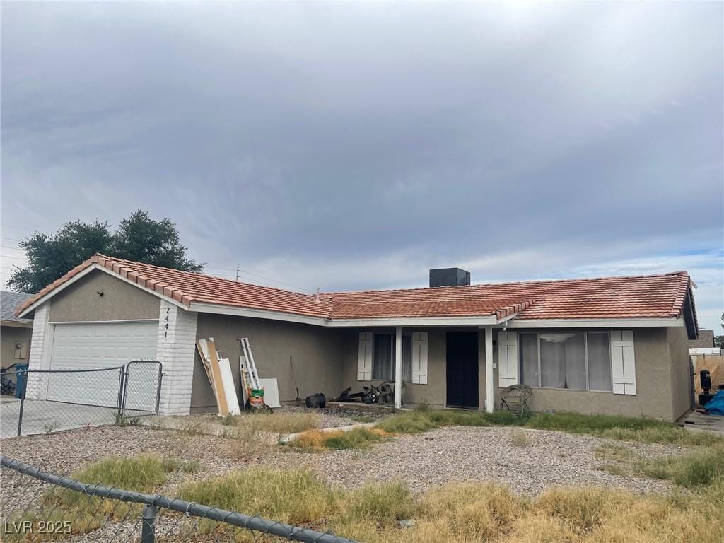 2441 Oak Glen Way, Las Vegas, NV 89115 - ranch-style home with a garage, stucco siding, a tile roof, and concrete driveway