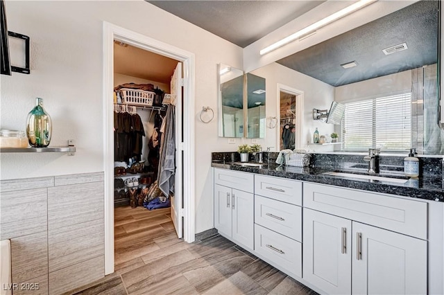 4308 Desert Haven Ave, North Las Vegas, NV 89085 - full bath featuring double vanity, a walk in closet, and wood finished floors