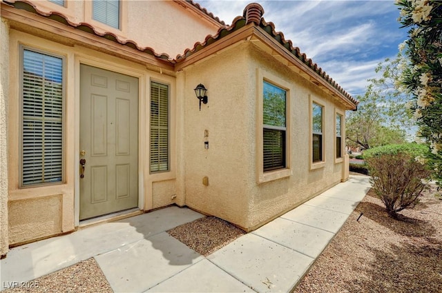 4308 Desert Haven Ave, North Las Vegas, NV 89085 - view of exterior entry with stucco siding and a tiled roof