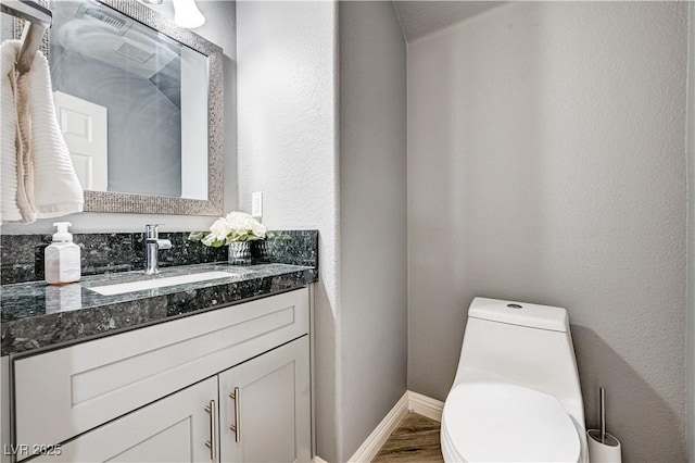 4308 Desert Haven Ave, North Las Vegas, NV 89085 - bathroom with vanity, toilet, baseboards, and wood finished floors