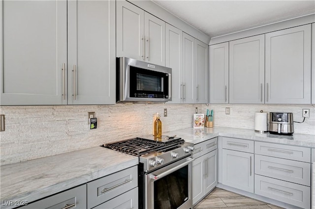 4308 Desert Haven Ave, North Las Vegas, NV 89085 - kitchen featuring appliances with stainless steel finishes, backsplash, and light stone counters