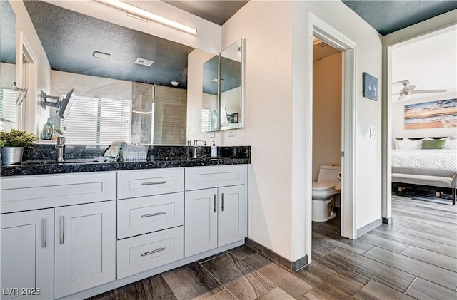 4308 Desert Haven Ave, North Las Vegas, NV 89085 - full bath with double vanity, wood finish floors, toilet, and connected bathroom