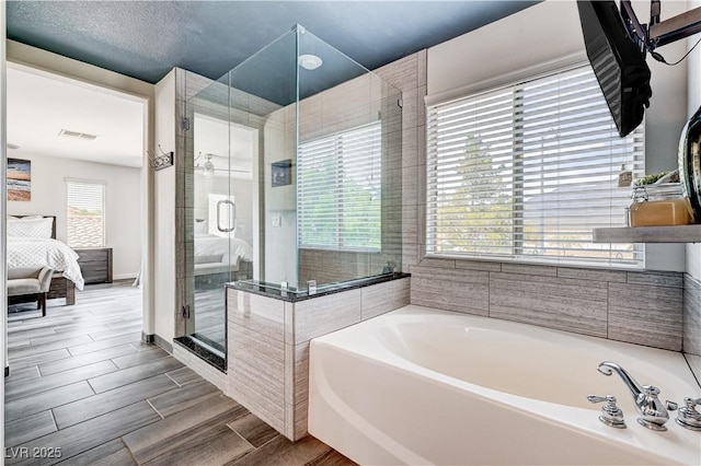 4308 Desert Haven Ave, North Las Vegas, NV 89085 - full bathroom featuring a bath, a shower stall, ensuite bath, and wood tiled floors