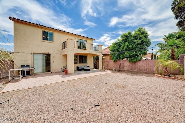 4308 Desert Haven Ave, North Las Vegas, NV 89085 - rear view of house featuring a balcony, a fenced backyard, stucco siding, and a patio area