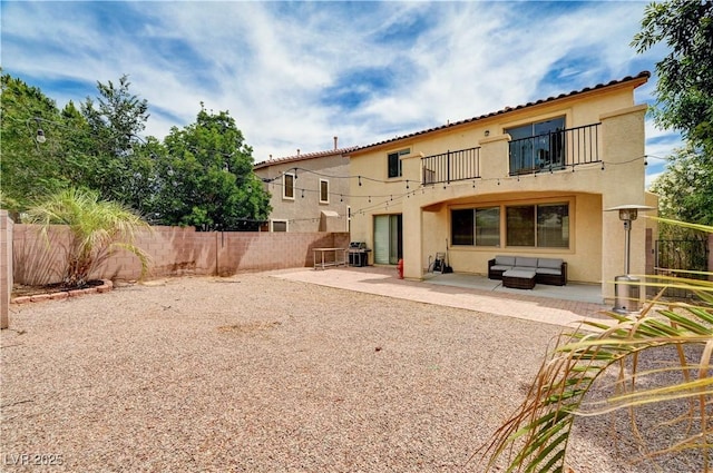 4308 Desert Haven Ave, North Las Vegas, NV 89085 - back of property with a balcony, stucco siding, a fenced backyard, and a patio area