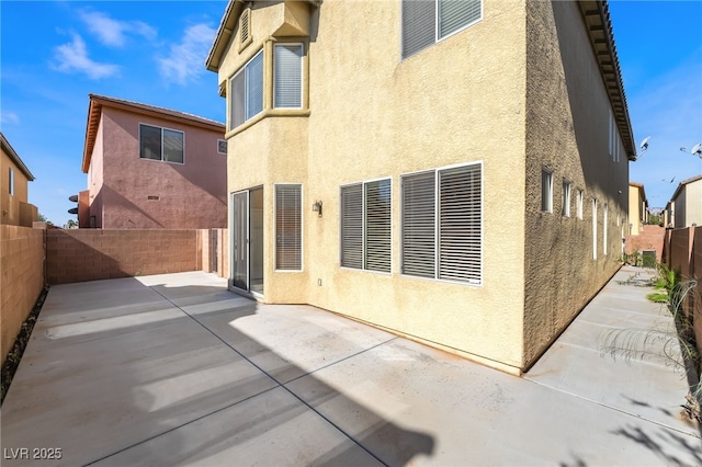 8109 Retriever Ave, Las Vegas, NV 89147 - back of house with stucco siding, a patio, and a fenced backyard