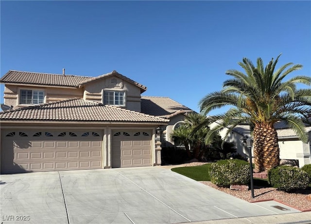 5104 Burr Oak Dr, Las Vegas, NV 89130 - view of front of house with concrete driveway, an attached garage, a tiled roof, and stucco siding