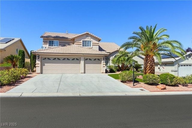 5104 Burr Oak Dr, Las Vegas, NV 89130 - view of front of house with a tiled roof, a garage, driveway, and stucco siding