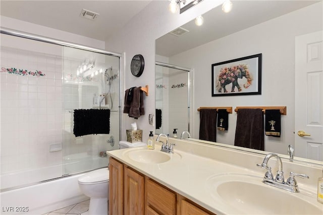 5104 Burr Oak Dr, Las Vegas, NV 89130 - full bathroom with toilet, shower / bath combination with glass door, double vanity, and tile patterned floors