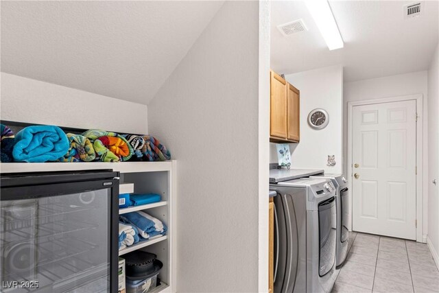 5104 Burr Oak Dr, Las Vegas, NV 89130 - laundry area with washer and clothes dryer, wine cooler, cabinet space, and light tile patterned floors