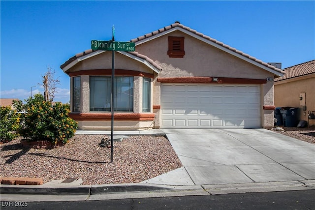 6520 Blooming Sun Ct, Las Vegas, NV 89142 - view of front facade with an attached garage, driveway, stucco siding, and a tile roof