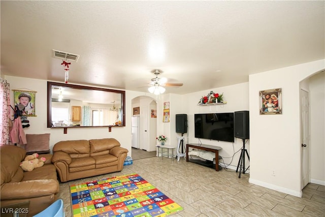 6520 Blooming Sun Ct, Las Vegas, NV 89142 - living room featuring arched walkways, a ceiling fan, and baseboards