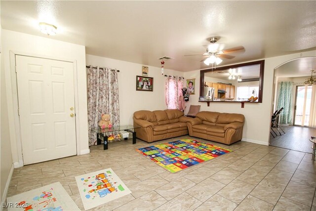 6520 Blooming Sun Ct, Las Vegas, NV 89142 - living area with ceiling fan, arched walkways, and baseboards