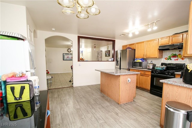 6520 Blooming Sun Ct, Las Vegas, NV 89142 - kitchen with appliances with stainless steel finishes, under cabinet range hood, arched walkways, a center island, and a chandelier