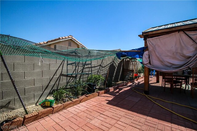 6520 Blooming Sun Ct, Las Vegas, NV 89142 - fenced backyard featuring a patio