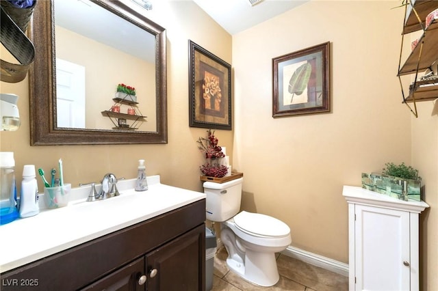 6529 Hartwood Rd, Las Vegas, NV 89108 - half bath featuring toilet, vanity, tile patterned floors, and baseboards