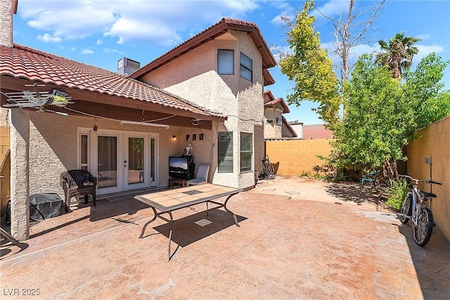 6529 Hartwood Rd, Las Vegas, NV 89108 - fenced backyard featuring french doors and a patio area