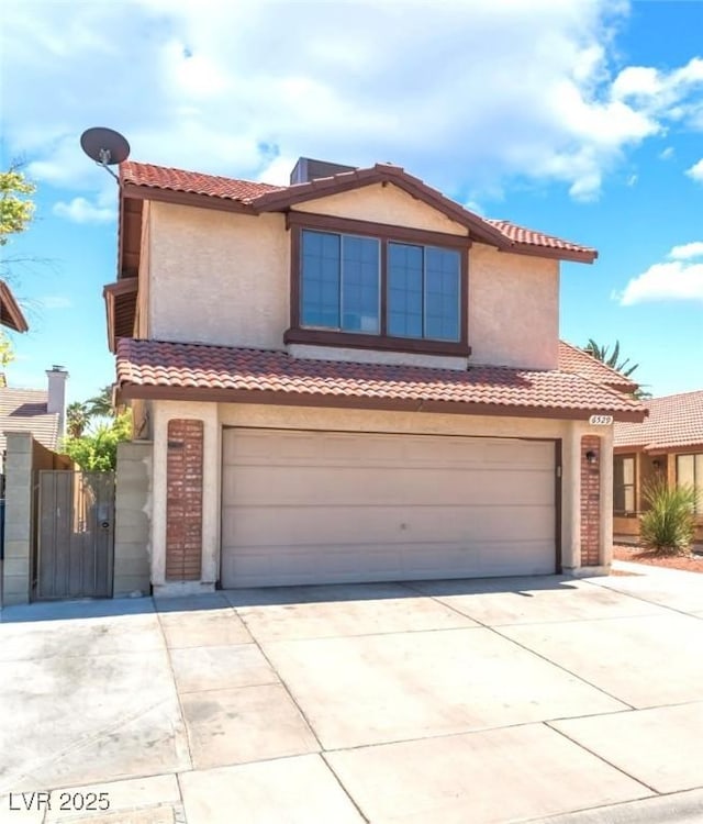 6529 Hartwood Rd, Las Vegas, NV 89108 - mediterranean / spanish-style house with a garage, concrete driveway, stucco siding, and a tile roof