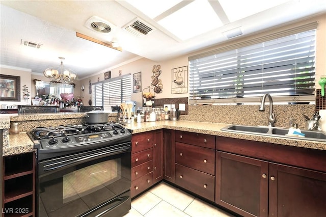 6529 Hartwood Rd, Las Vegas, NV 89108 - kitchen with black range with gas cooktop, a sink, a chandelier, light tile patterned flooring, and light stone counters