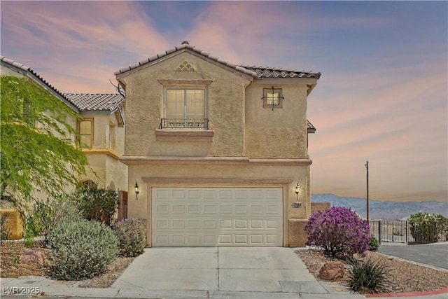 10650 Little Horse Creek Ave, Las Vegas, NV 89129 - mediterranean / spanish house with a garage, stucco siding, a tile roof, and driveway