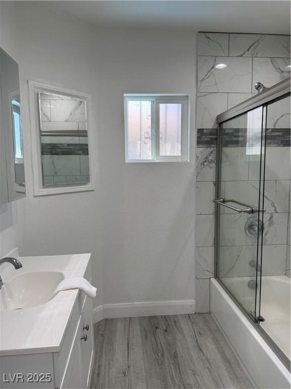 621 S 9th St, Las Vegas, NV 89101 - bathroom featuring enclosed tub / shower combo, vanity, and wood finished floors