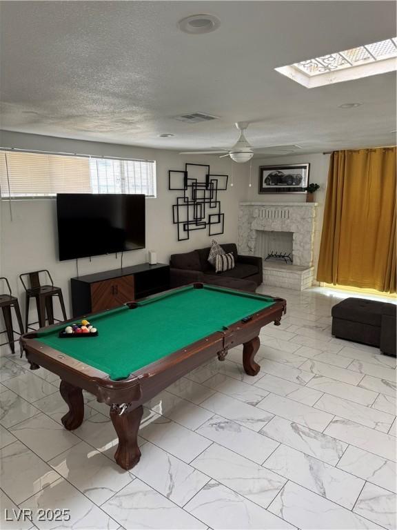 621 S 9th St, Las Vegas, NV 89101 - recreation room with light marble finish floors, pool table, a fireplace, a skylight, and ceiling fan
